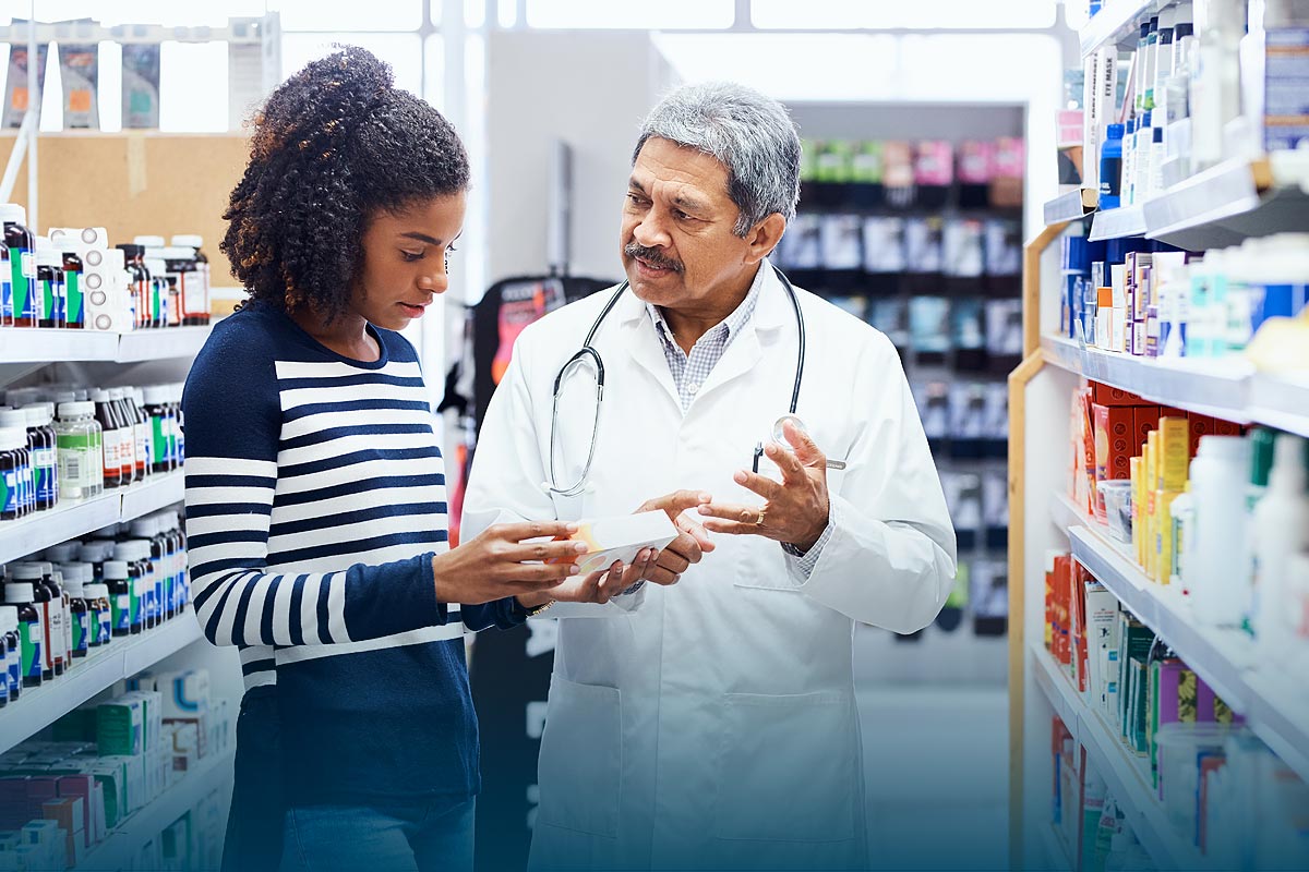 Pharmacist assisting customer picking out a prescription