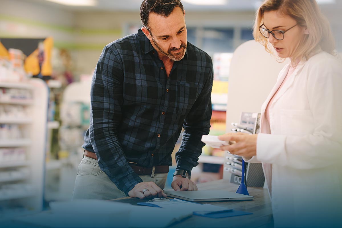 Pharmacist explaining prescription to patient