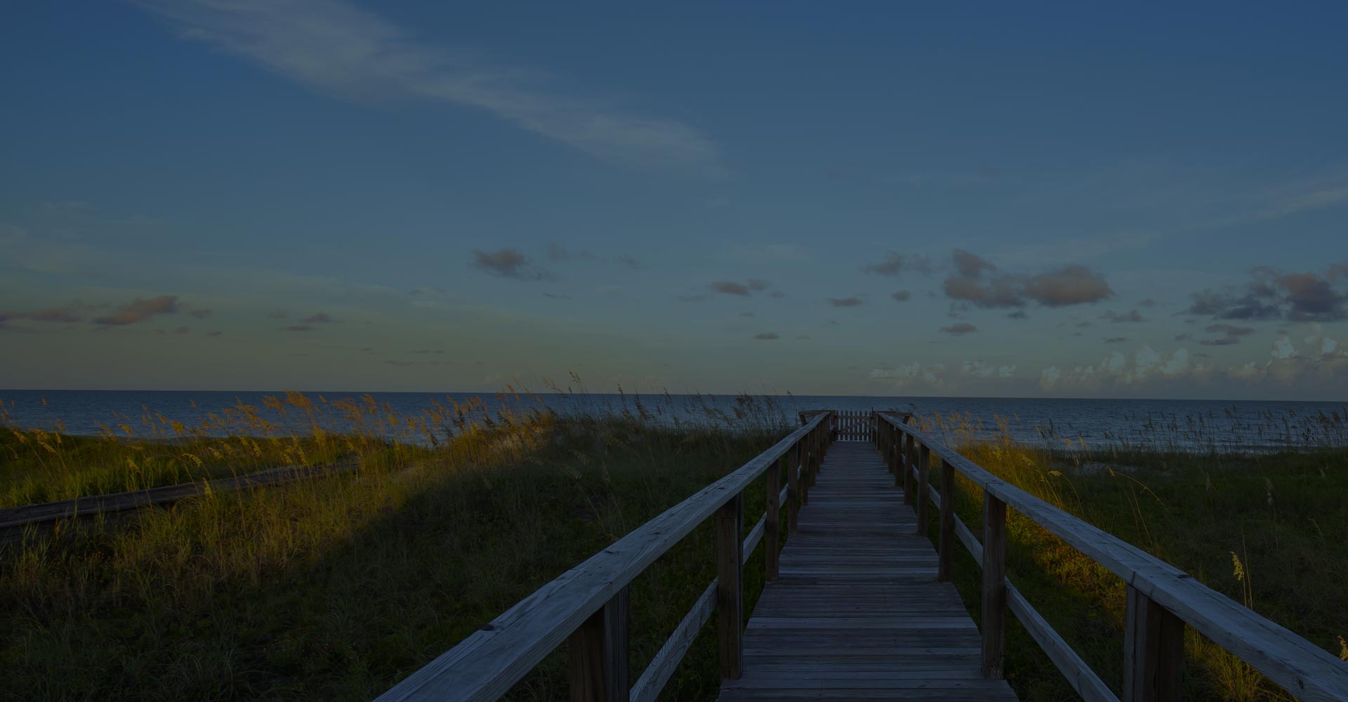 Shot of pier leading out to ocean