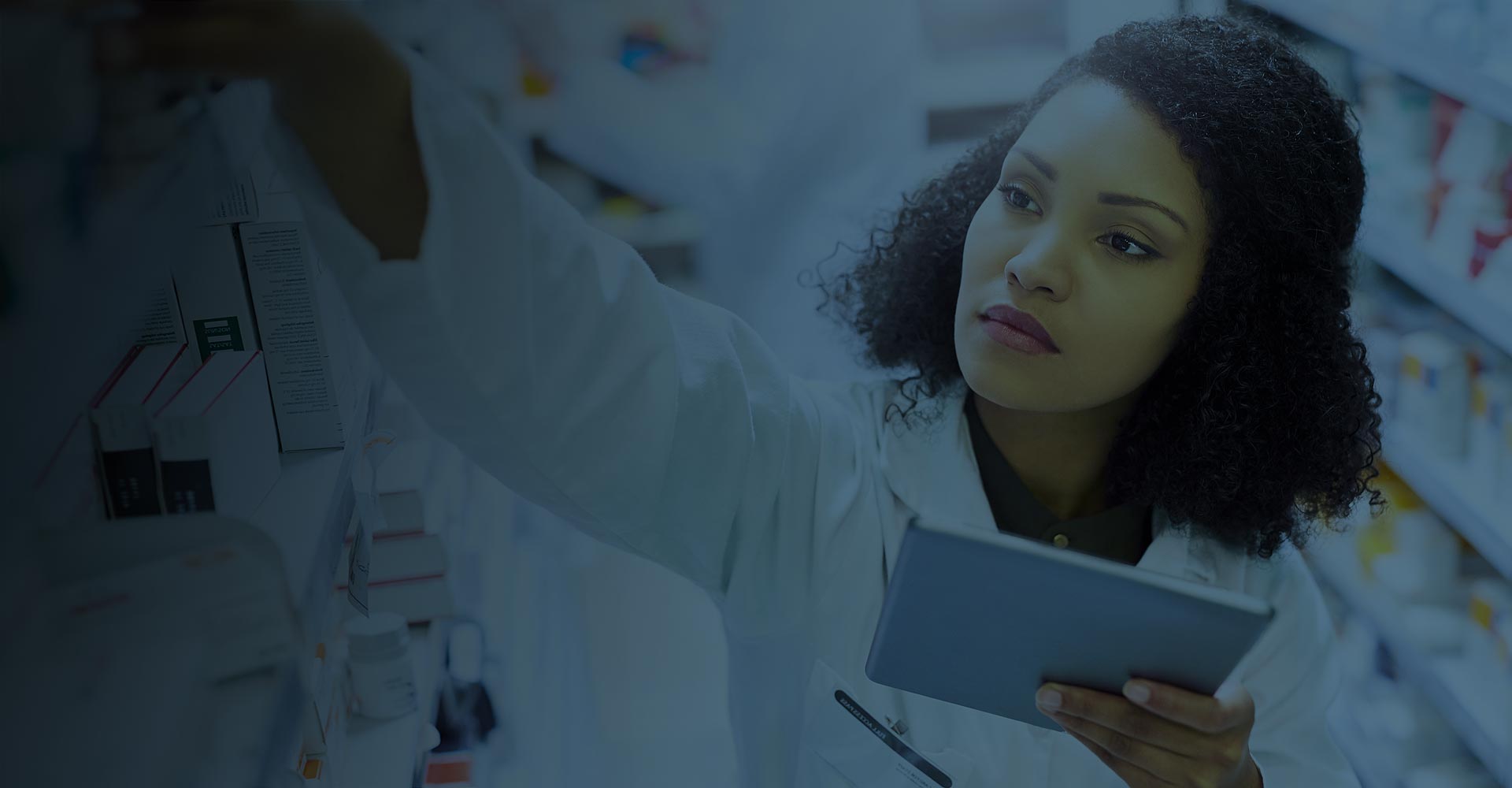 Pharmacist using tablet to pick out inventory