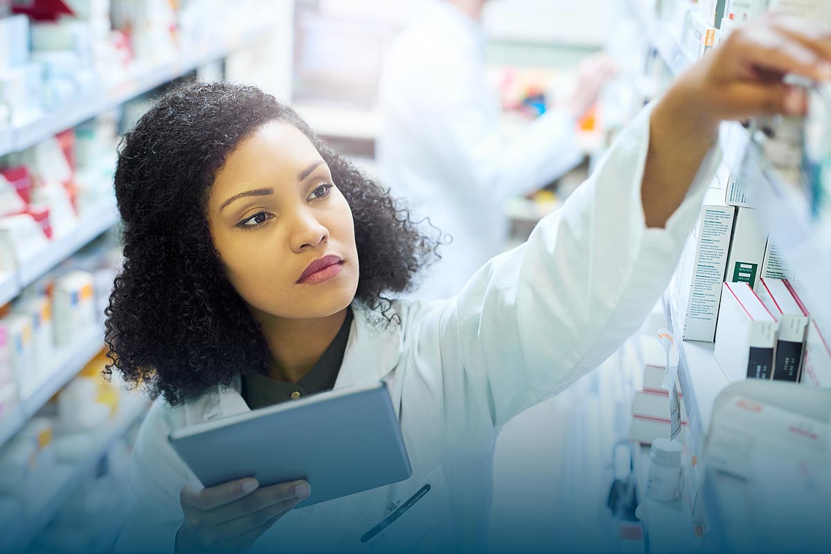 Pharmacist using tablet for inventory management